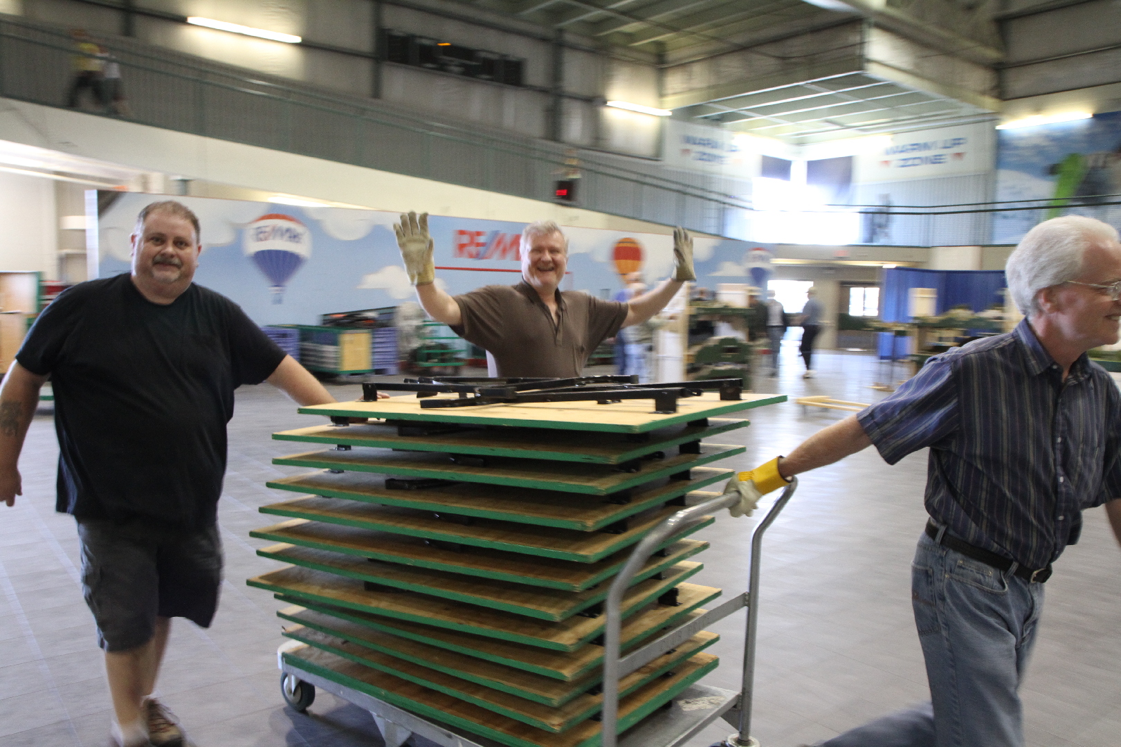 three people from NALUG moving tables